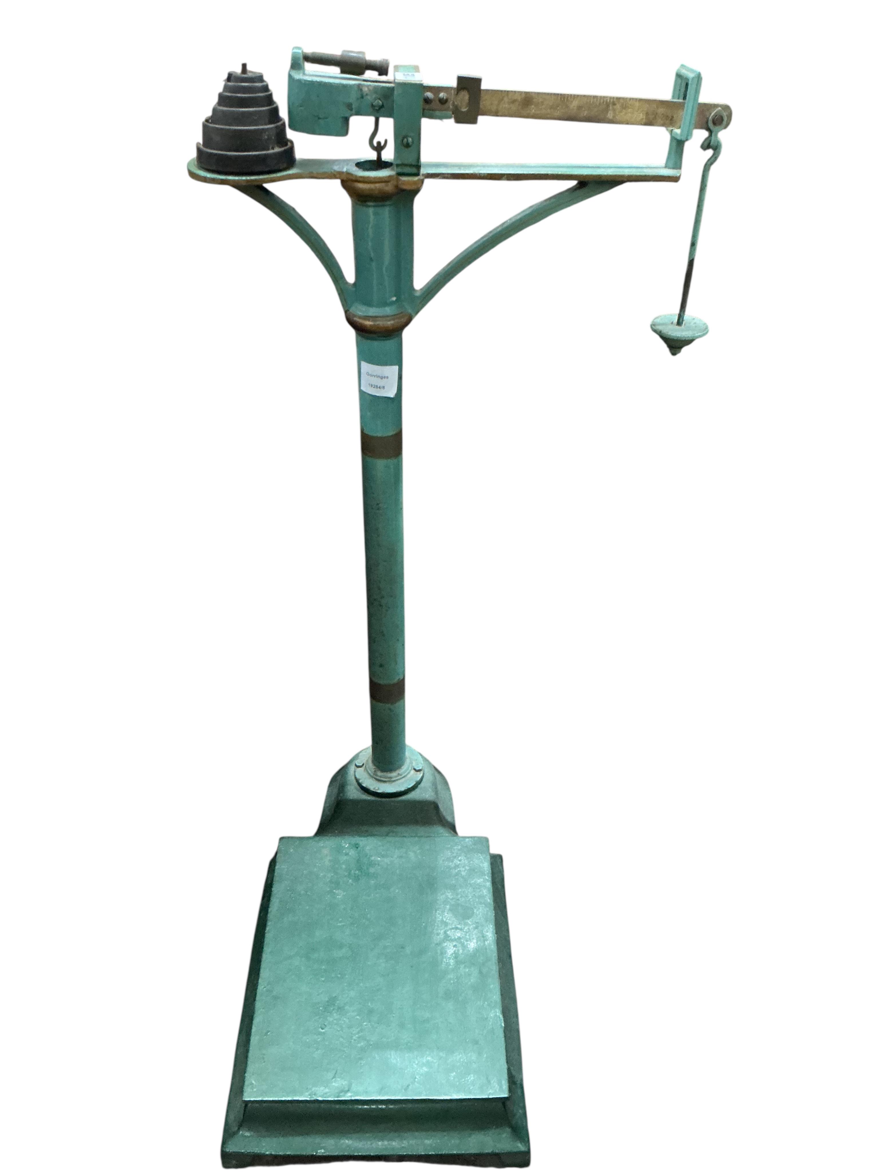 A set of late Victorian green painted cast iron medical scales and weights, height 93cm